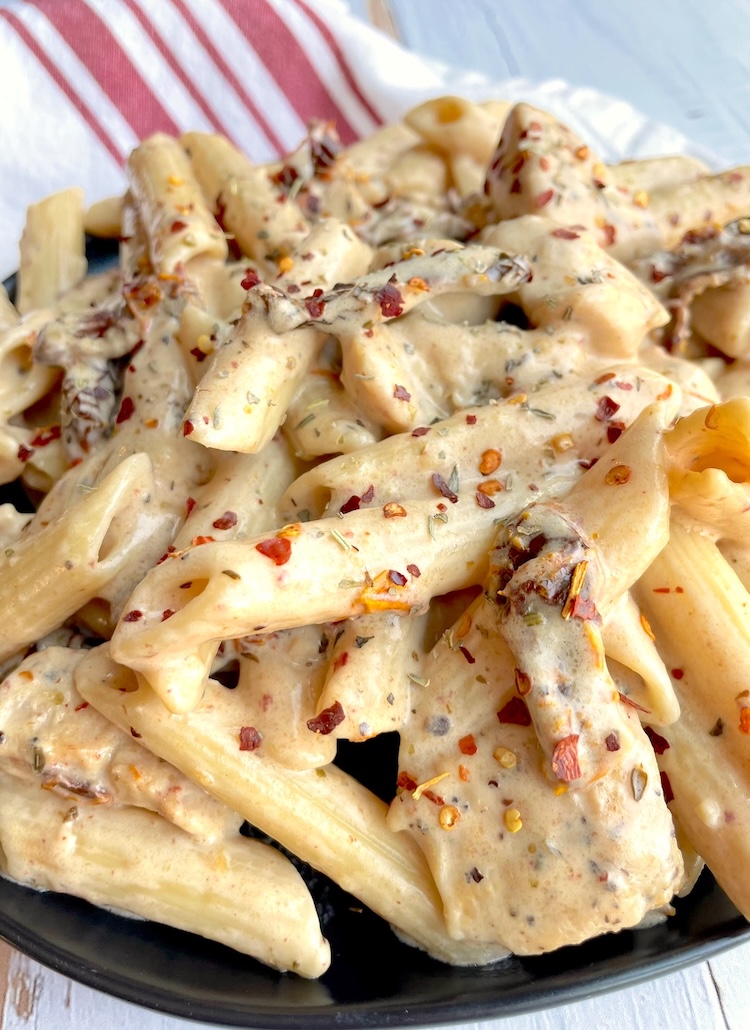 The best cream sun dried tomato pasta recipe! Easy to make with homemade creamy sauce and sautéed chicken. 