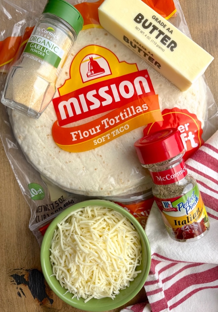 How to make garlic bread in your air fryer with flour tortillas, butter, shredded cheese, garlic powder, and Italian seasoning. 