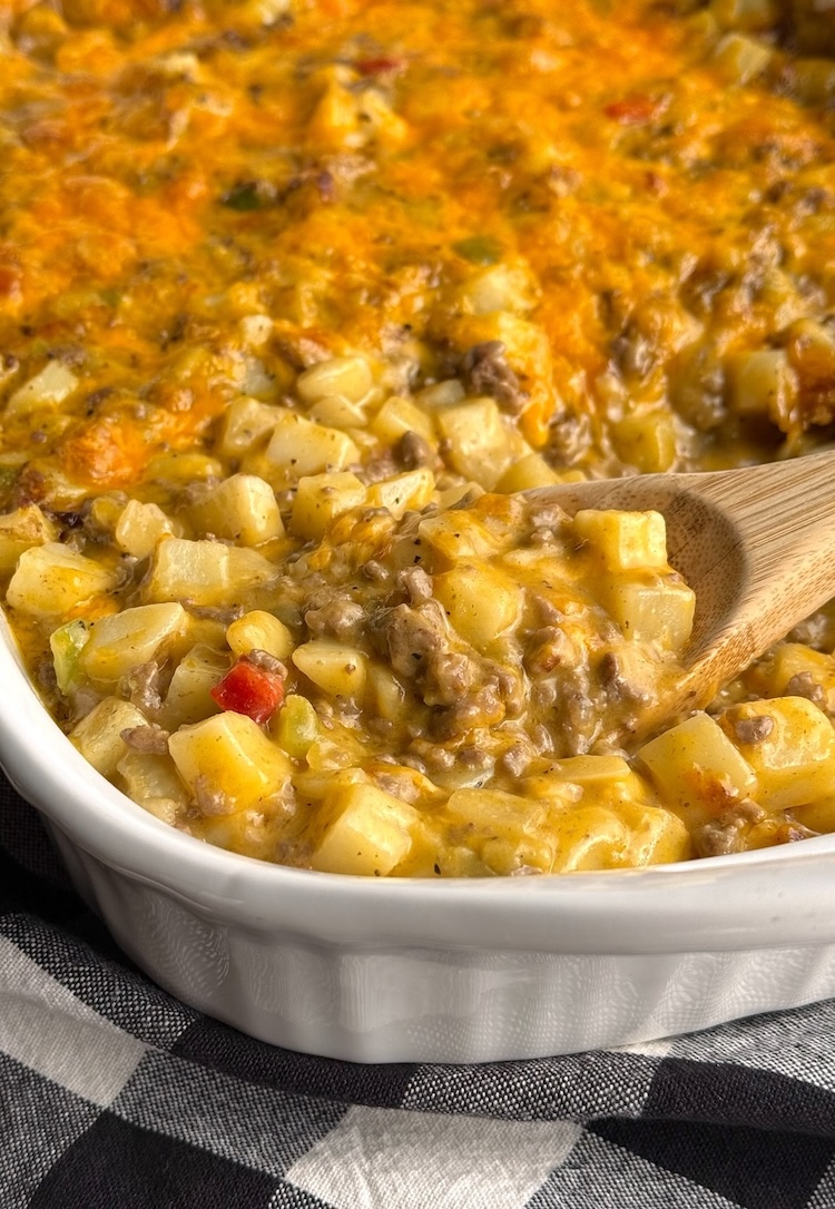 Delicious family dinner casserole made with cheesy ground beef, frozen potatoes, soup, and seasoning. 