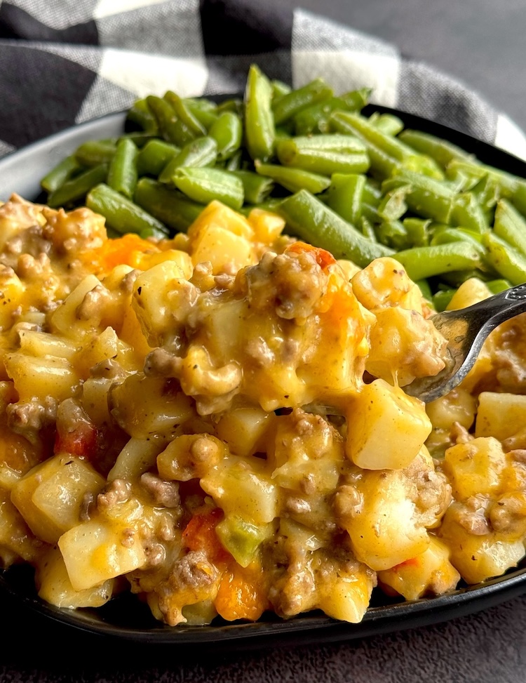 Yummy beef and potato casserole with a side of green beans.