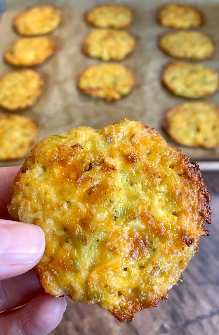 How to easily make broccoli cheese bites with frozen broccoli or cauliflower rice! Smash the batter down onto a sheet pan to make them extra crispy and delicious. Your picky eaters are going to love this healthy snack idea!