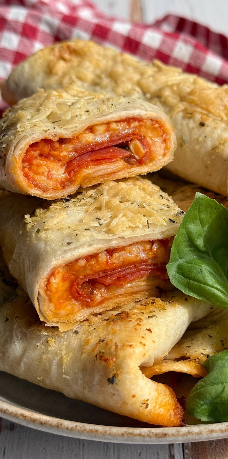 I'm always searching for easy meals to make for my kids, and these pizza burritos were a huge hit with my picky eaters! Such a fun and creative way to make pizza by wrapping all of the traditional pizza ingredients into a flour tortilla and baking with loads of garlic butter. Delicious and so simple!