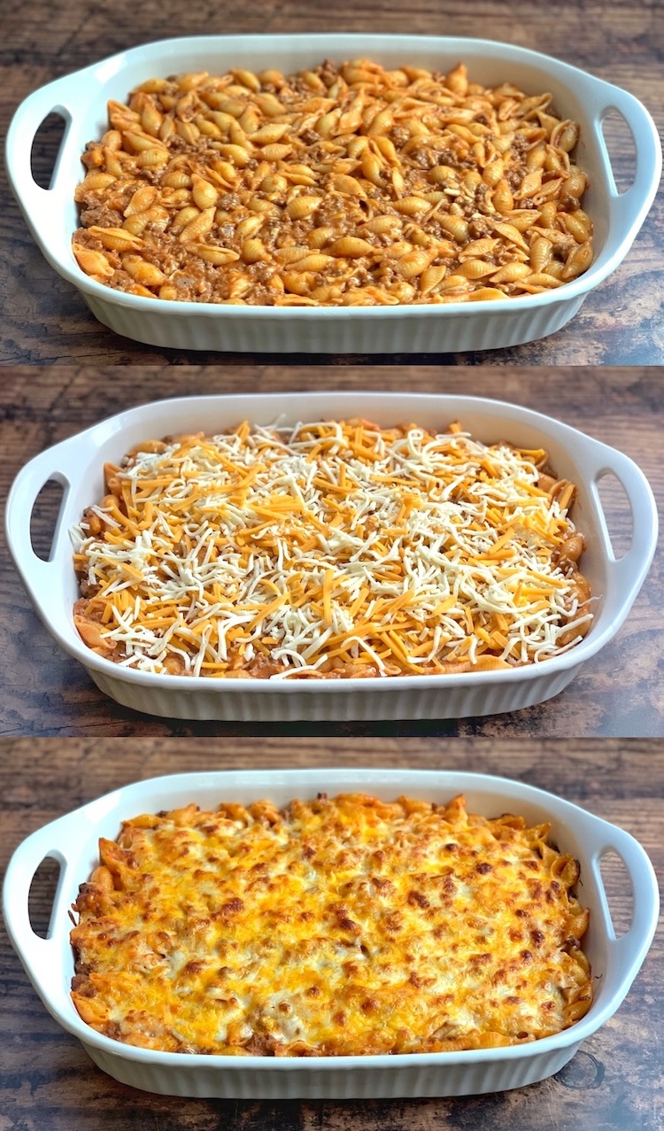 A mixture of ground beef, pasta, cheese, and tomato soup in a large casserole dish topped with lots of shredded cheese. 