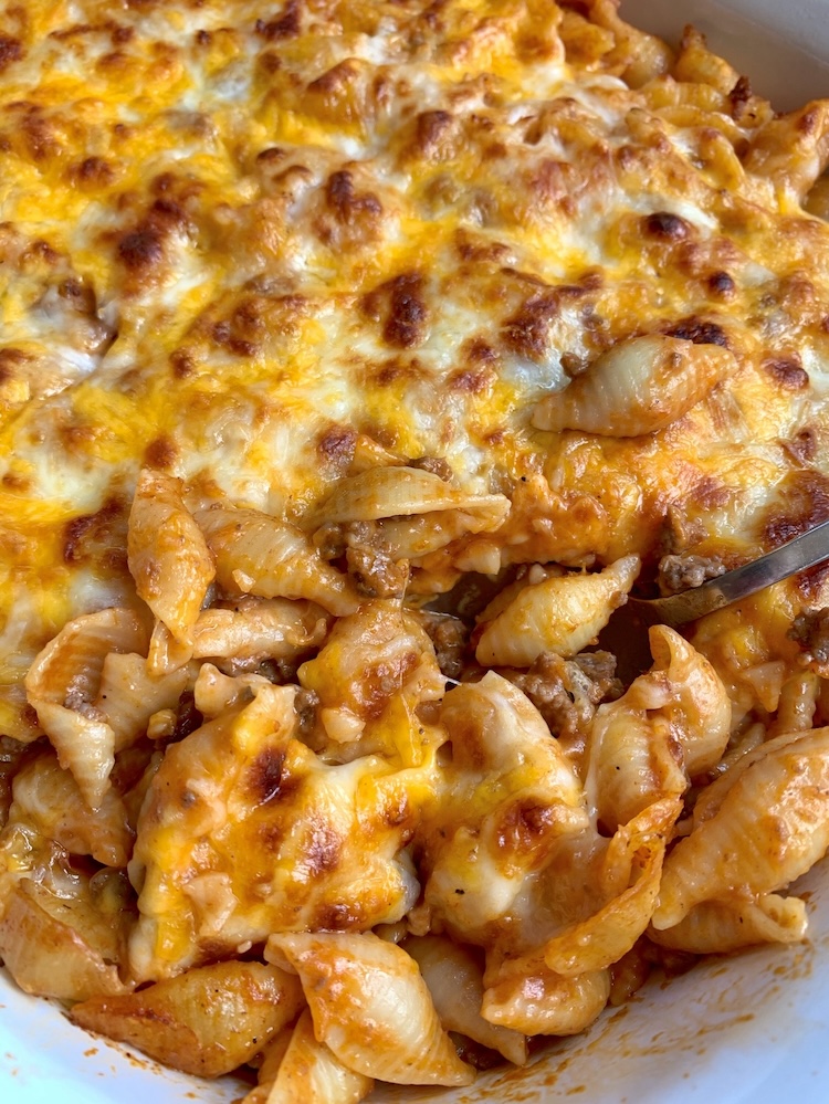 Close up view of a delicious cheesy hamburger and pasta dinner casserole. A kid friendly comfort food recipe that's easy for mom and dad to make on busy school nights!