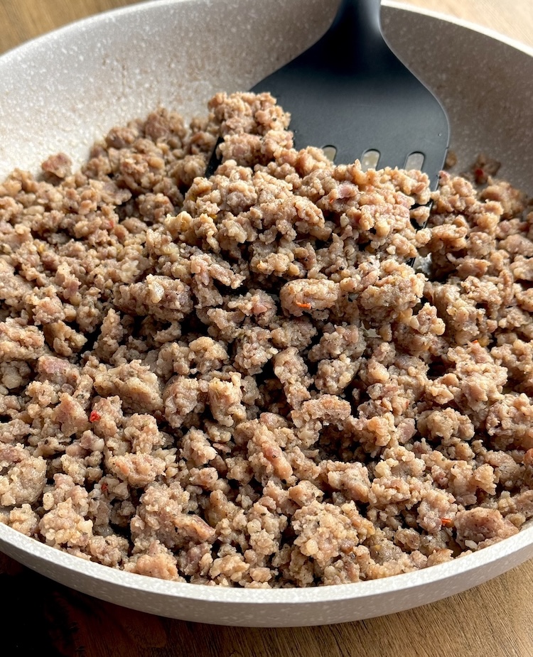 Cooked ground pork sausage in a pan. 